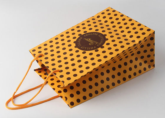 ナイロン ハンドルの金ホイルの熱いスタンプおよびドット・パターンが付いている装飾的なギフトのパッキング袋